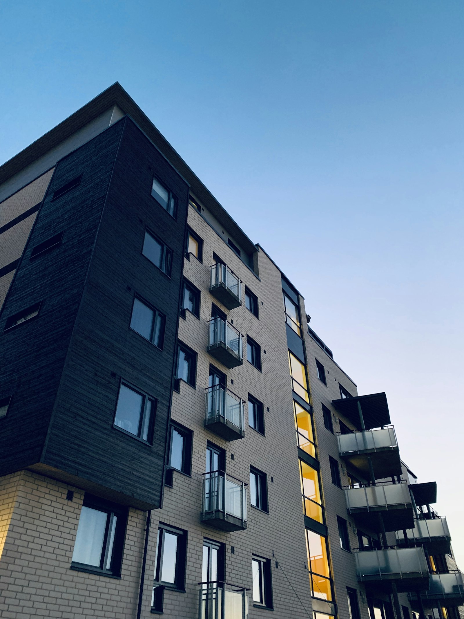 Modern residential building with balconies at dusk